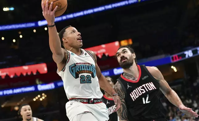 Memphis Grizzlies guard Desmond Bane (22) looks to shoot against Houston Rockets center Steven Adams, right, in the second half of an NBA basketball game Thursday, Jan. 30, 2025, in Memphis, Tenn. (AP Photo/Brandon Dill)