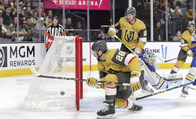 Vegas Golden Knights center Tanner Laczynski (28) scores against Buffalo Sabres goaltender James Reimer, second from bottom left, during the first period of an NHL hockey game Saturday, Jan. 4, 2025, in Las Vegas (Steve Marcus/Las Vegas Sun via AP)