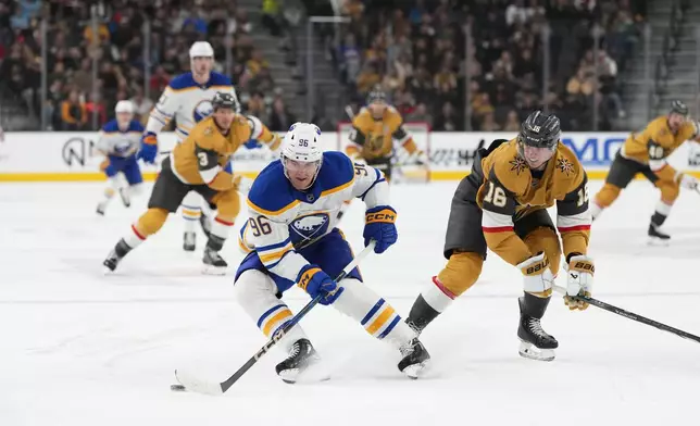 Buffalo Sabres right wing Nicolas Aube-Kubel (96) skates with the puck against Vegas Golden Knights left wing Pavel Dorofeyev (16) during the first period of an NHL hockey game, Saturday, Jan. 4, 2025, in Las Vegas. (AP Photo/Lucas Peltier)