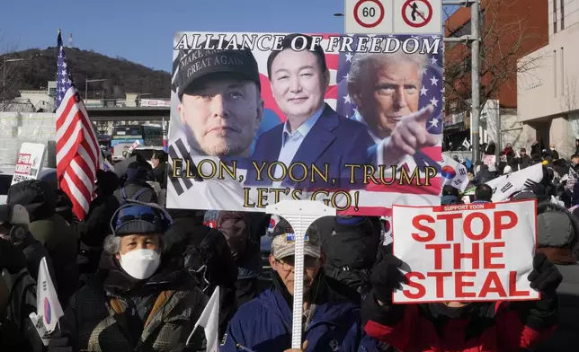 Supporters of impeached South Korean President Yoon Suk Yeol attend with a banner showing portraits of him, center, US President-elect Donald Trump and Tesla and SpaceX CEO Elon Musk, left, during a rally to oppose his impeachment near the presidential residence in Seoul, South Korea, Friday, Jan. 10, 2025. (AP Photo/Ahn Young-joon)