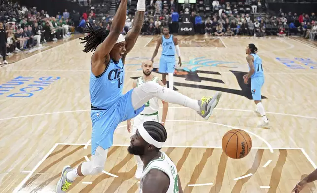 Los Angeles Clippers guard Terance Mann, left, dunks as Boston Celtics center Neemias Queta stands by during the first half of an NBA basketball game, Wednesday, Jan. 22, 2025, in Inglewood, Calif. (AP Photo/Mark J. Terrill)