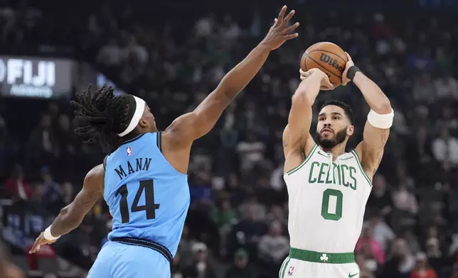 Boston Celtics forward Jayson Tatum, right, shoots as Los Angeles Clippers guard Terance Mann defends during the first half of an NBA basketball game, Wednesday, Jan. 22, 2025, in Inglewood, Calif. (AP Photo/Mark J. Terrill)