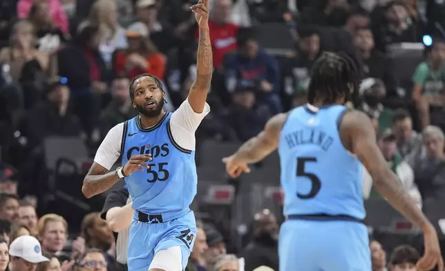 Los Angeles Clippers forward Derrick Jones Jr., left, gestures after hitting a three-point shot as guard Bones Hyland points at him during the first half of an NBA basketball game against the Boston Celtics, Wednesday, Jan. 22, 2025, in Inglewood, Calif. (AP Photo/Mark J. Terrill)
