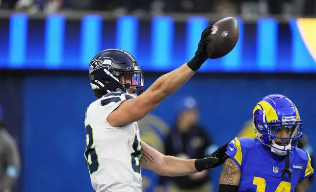 Seattle Seahawks tight end AJ Barner (88) celebrates after catching a touchdown during the second half of an NFL football game against the Los Angeles Rams, Sunday, Jan. 5, 2025, in Inglewood, Calif. (AP Photo/Mark J. Terrill)