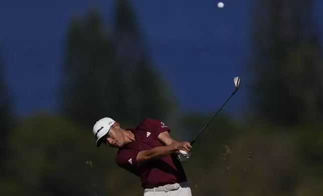 Collin Morikawa watches his shot on the fourth hole during the final round of The Sentry golf event, Sunday, Jan. 5, 2025, at Kapalua Plantation Course in Kapalua, Hawaii. (AP Photo/Matt York)