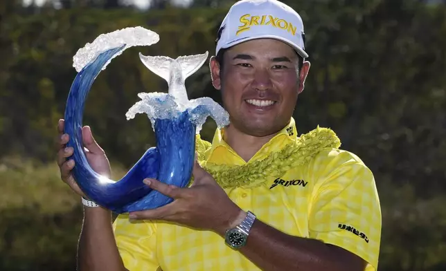 Hideki Matsuyama, of Japan, holds the champions trophy after the final round of The Sentry golf event, Sunday, Jan. 5, 2025, at Kapalua Plantation Course in Kapalua, Hawaii. (AP Photo/Matt York)