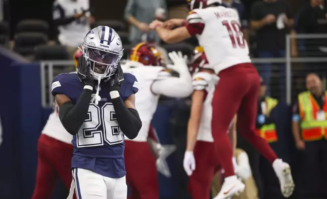 Dallas Cowboys cornerback DaRon Bland (26) reacts after Washington Commanders wide receiver Terry McLaurin caught a touchdown pass in front of him during the second half of an NFL football game, Sunday, Jan. 5, 2025, in Arlington, Texas. The Commanders won 23-19. (AP Photo/Gareth Patterson)