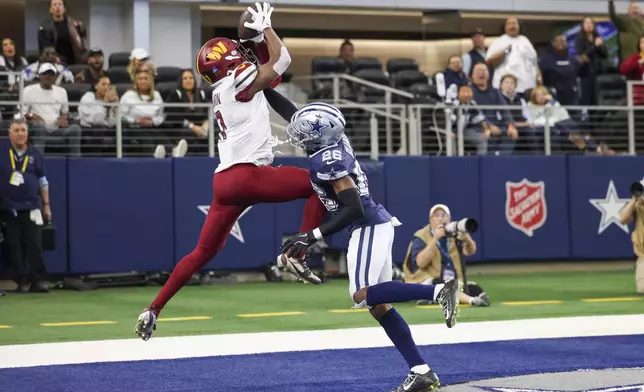 Washington Commanders wide receiver Terry McLaurin, left, goes up to make a touchdown catch against Dallas Cowboys cornerback DaRon Bland during the second half of an NFL football game, Sunday, Jan. 5, 2025, in Arlington, Texas. The Commanders won 23-19. (AP Photo/Gareth Patterson)