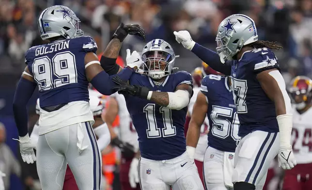 Dallas Cowboys linebacker Micah Parsons (11) celebrates a sack with defensive end Chauncey Golston (99) and linebacker Buddy Johnson (57) during the first half of an NFL football game against the Washington Commanders, Sunday, Jan. 5, 2025, in Arlington, Texas. (AP Photo/Josh McSwain)