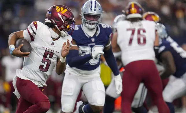 Washington Commanders quarterback Jayden Daniels (5) runs with the ball as Dallas Cowboys defensive end Chauncey Golston (99) chases him during the first half of an NFL football game, Sunday, Jan. 5, 2025, in Arlington, Texas. (AP Photo/Josh McSwain)