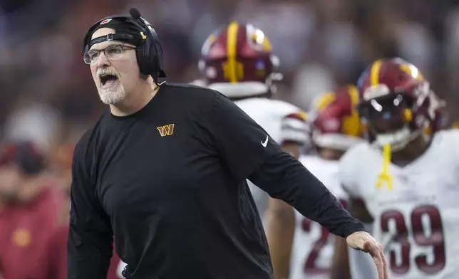 Washington Commanders head coach Dan Quinn reacts to a fourth-down stop against the Dallas Cowboys during the first half of an NFL football game, Sunday, Jan. 5, 2025, in Arlington, Texas. (AP Photo/Gareth Patterson)