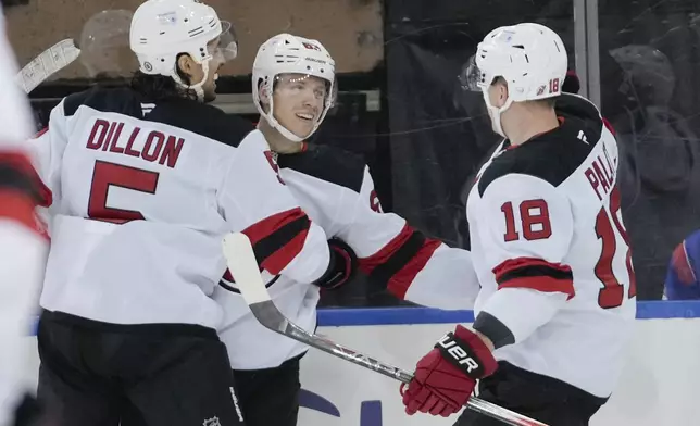 New Jersey Devils' Jesper Bratt (63) celebrates with teammates after scoring a goal during the second period of an NHL hockey game against the New York Rangers, Thursday, Jan. 9, 2025, in New York. (AP Photo/Frank Franklin II)