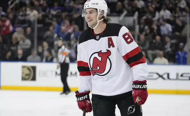 New Jersey Devils' Jack Hughes (86) smiles after scoring a goal during the second period of an NHL hockey game against the New York Rangers, Thursday, Jan. 9, 2025, in New York. (AP Photo/Frank Franklin II)