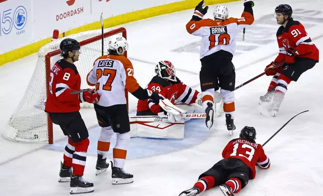 Philadelphia Flyers right wing Bobby Brink (10) celebrates after scoring a goal past New Jersey Devils goaltender Jake Allen (34) during the third period of an NHL hockey game, Saturday, Jan. 18, 2025, in Newark, N.J. (AP Photo/Noah K. Murray)