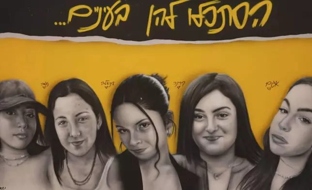 FILE - A mural of female Israeli soldiers who were abducted and brought to Gaza is displayed in Tel Aviv, Israel, Saturday, Jan. 25, 2025. (AP Photo/Ariel Schalit, File)