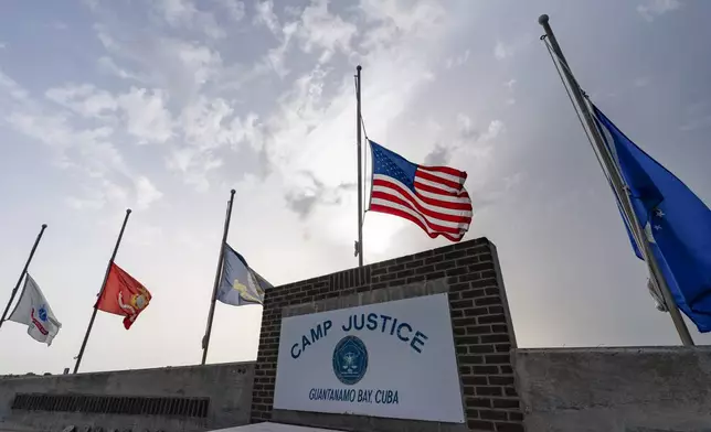 FILE - In this photo reviewed by U.S. military officials, flags fly at half-staff at Camp Justice, Aug. 29, 2021, in Guantanamo Bay Naval Base, Cuba. (AP Photo/Alex Brandon, File)