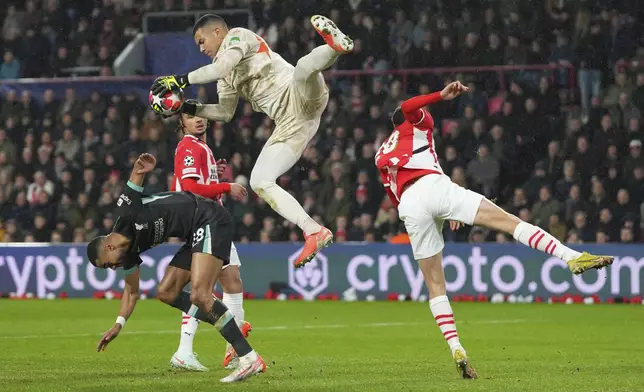PSV's goalkeeper Walter Benitez saves over Liverpool's Cody Gakpo during the Champions League opening phase soccer match between PSV and Liverpool at Phillips Stadium in Eindhoven, Netherlands, Wednesday, Jan. 29, 2025. (AP Photo/Peter Dejong)