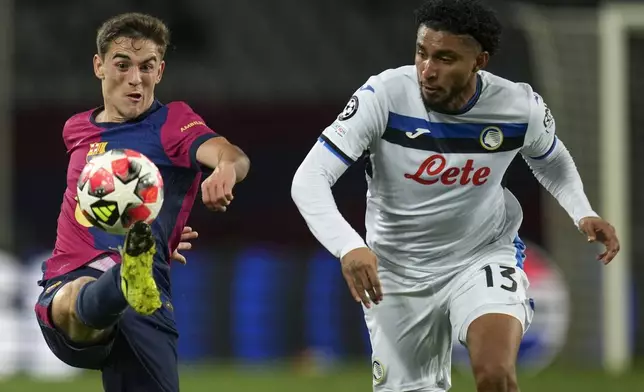 Barcelona's Gavi, left, vies for the ball with Atalanta's Ederson during a Champions League opening phase soccer between Barcelona and Atalanta match at the Lluis Companys Olympic stadium in Barcelona, Spain, Wednesday, Jan. 29, 2025. (AP Photo/Emilio Morenatti)
