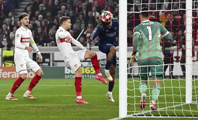 PSG's Bradley Barcola, centre right, scores the opening goal past Stuttgart's goalkeeper Fabian Bredlow during the Champions League opening phase soccer match between VfB Stuttgart and Paris Saint-Germain in Stuttgart, Germany, Jan. 29, 2025. (Marijan Murat/dpa via AP)