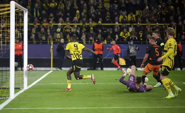 Dortmund's Serhou Guirassy scores the opening goal during the Champions League opening phase soccer match between Borussia Dortmund and Shakhtar Donetsk in Dortmund, Germany, Jan. 29, 2025. (Bernd Thissen/dpa via AP)