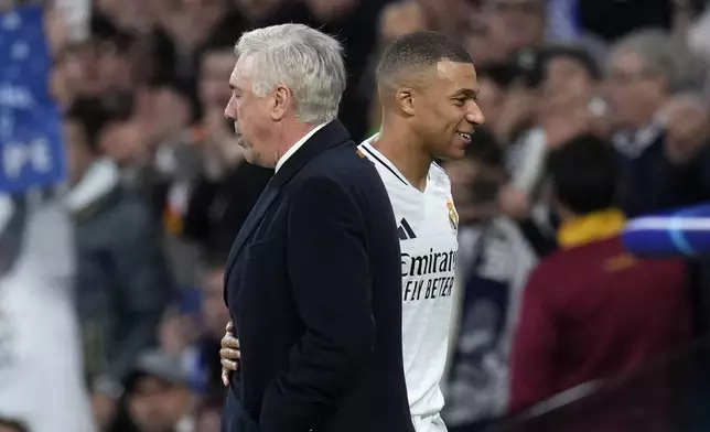 Real Madrid's Kylian Mbappe, right, hugs his coach Carlo Ancelotti as he leaves the pitch during the Champions League opening phase soccer match between Real Madrid and FC Salzburg at the Santiago Bernabeu stadium in Madrid, Wednesday, Jan. 22, 2025. (AP Photo/Manu Fernandez)