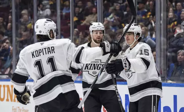 Los Angeles Kings' Alex Turcotte (15) celebrates after his goal against the Vancouver Canucks with Adrian Kempe (9) and Anze Kopitar (11) during the first period of an NHL hockey game in Vancouver, British Columbia, Thursday, Jan. 16, 2025. (Ethan Cairns/The Canadian Press via AP)