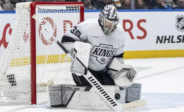 Los Angeles Kings goaltender Darcy Kuemper (35) stops the puck against the Vancouver Canucks during the third period of an NHL hockey game in Vancouver, British Columbia, Thursday, Jan. 16, 2025. (Ethan Cairns/The Canadian Press via AP)