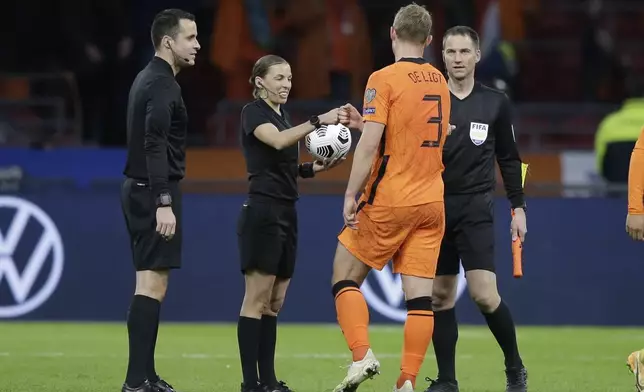 FILE -Referee Stephanie Frappart cheers with Netherlands' Matthijs de Ligt at the end of the World Cup 2022 group G qualifying soccer match between The Netherlands and Latvia at the Johan Cruyff ArenA in Amsterdam, Netherlands, Saturday, March 27, 2021. (AP Photo/Peter Dejong, File)