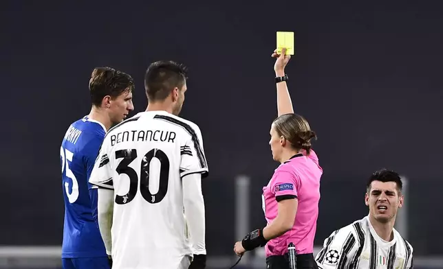 FILE -Dynamo Kyiv's Illya Zabarnyi gets a yellow card from referee Stephanie Frappart during a Champions League, group G soccer match between Juventus and Dinamo Kiev at the Allianz Stadium in Turin, Italy, Wednesday, Dec. 2, 2020. (Marco Alpozzi/LaPresse via AP, File)
