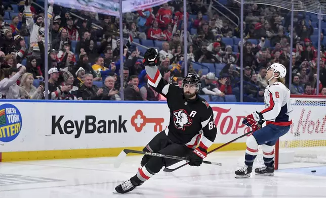 Buffalo Sabres right wing Alex Tuch, left, celebrates after scoring as Washington Capitals defenseman Jakob Chychrun, right,reacts during the second period of an NHL hockey game in Buffalo, N.Y., Monday, Jan. 6, 2025. (AP Photo/Adrian Kraus)