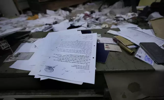 Documents lie scattered at Branch 215, a detention facility run by military intelligence during Assad's regime, in Damascus, Syria, on Dec. 17, 2024. (AP Photo/Hussein Malla)