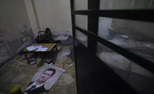 A portrait of ousted Syrian president Bashar Assad lies on the ground at Branch 215, a detention facility run by military intelligence during Bashar Assad's regime in Damascus, Syria, on Dec. 17, 2024. (AP Photo/Hussein Malla)