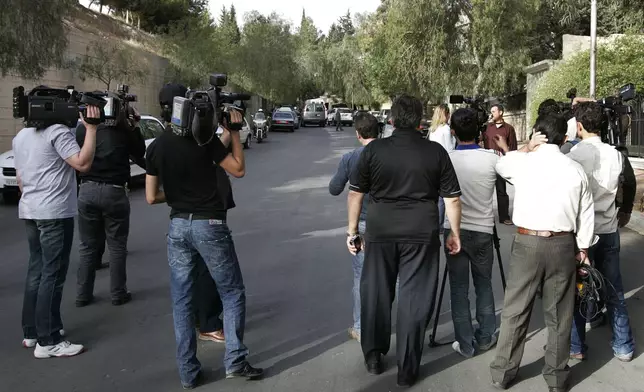 FILE - Syrian cameramen and journalists wait after they were prevented from covering a meeting between former U.S. President Jimmy Carter and Hamas political leader Khaled Mashaal in Damascus, Syria, on April 18, 2008. (AP Photo/Hussein Malla, File)