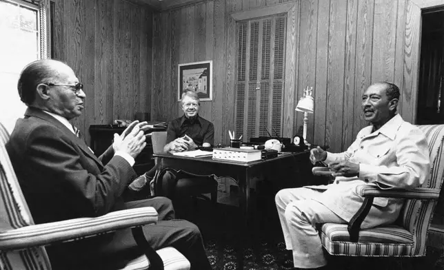 FILE - In this Official White House photo, Israeli Prime Minister Menachem Begin, left, President Jimmy Carter, center, and Egyptian President Anwar Sadat begin their second day of peace talks at Camp David, Md., on Sept. 7, 1978. (AP Photo/Official White House Photo, File)