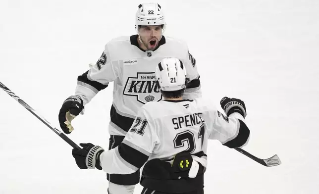 Los Angeles Kings left wing Kevin Fiala (22) celebrates his goal withJordan Spence (21) against the Detroit Red Wings in the first period of an NHL hockey game Monday, Jan. 27, 2025, in Detroit. (AP Photo/Paul Sancya)