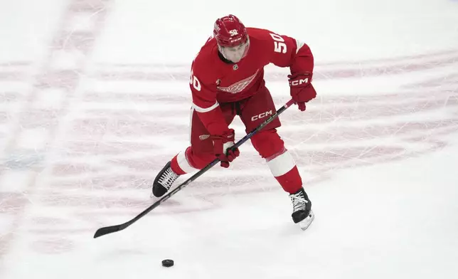 Detroit Red Wings right wing Dominik Shine (50) shoots against the Los Angeles Kings in the second period of an NHL hockey game Monday, Jan. 27, 2025, in Detroit. (AP Photo/Paul Sancya)