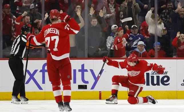 Detroit Red Wings center Marco Kasper (92) celebrates his goal against the Tampa Bay Lightning with defenseman Simon Edvinsson (77) during the second period of an NHL hockey game Saturday, Jan. 25, 2025, in Detroit. (AP Photo/Duane Burleson)