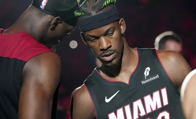 Miami Heat forward Jimmy Butler (22) and center Bam Adebayo, left, are introduced before an NBA basketball game against the Indiana Pacers Thursday, Jan. 2, 2025, in Miami. (AP Photo/Lynne Sladky)