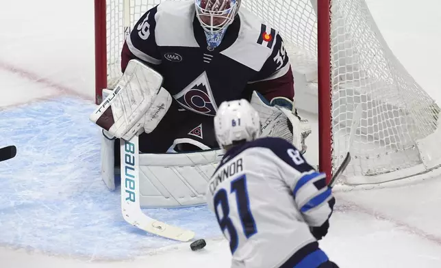 Winnipeg Jets left wing Kyle Connor (81) shoots against Colorado Avalanche goaltender Mackenzie Blackwood (39) in the third period of an NHL hockey game Tuesday, Dec. 31, 2024, in Denver. (AP Photo/David Zalubowski)