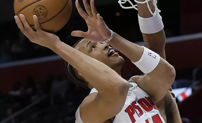 Detroit Pistons guard Wendell Moore Jr. (14) gets a shot off against the Portland Trail Blazers during the first half of an NBA basketball game Monday, Jan. 6, 2025, in Detroit. (AP Photo/Duane Burleson)