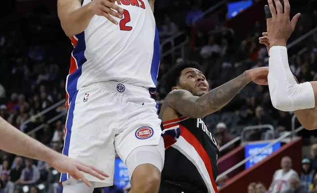 Detroit Pistons guard Cade Cunningham (2) lays up a shot over Portland Trail Blazers guard Anfernee Simons during the first half of an NBA basketball game, Monday, Jan. 6, 2025, in Detroit. (AP Photo/Duane Burleson)