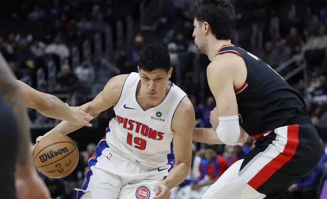 Detroit Pistons forward Simone Fontecchio (19) drives the lane against Portland Trail Blazers forward Deni Avdija, right, during the first half of an NBA basketball game, Monday, Jan. 6, 2025, in Detroit. (AP Photo/Duane Burleson)