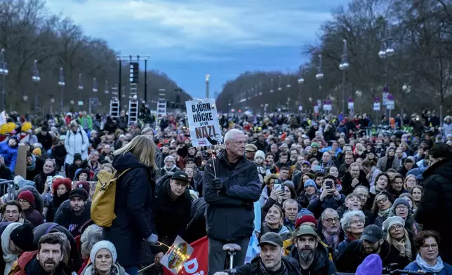 People gather to protest against the far-right Alternative for Germany, or AfD party, and right-wing extremism in front of the Brandenburg Gate in Berlin, Germany, Saturday, Jan. 25, 2025. (AP Photo/Ebrahim Noroozi)