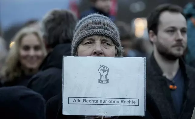 People gather to protest against the far-right Alternative for Germany, or AfD party, and right-wing extremism in front of the Brandenburg Gate in Berlin, Germany, Saturday, Jan. 25, 2025. (AP Photo/Ebrahim Noroozi)