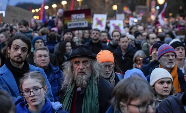 People gather to protest against the far-right Alternative for Germany, or AfD party, and right-wing extremism in front of the Brandenburg Gate in Berlin, Germany, Saturday, Jan. 25, 2025. (AP Photo/Ebrahim Noroozi)