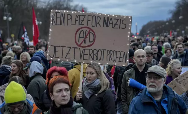 People gather to protest against the far-right Alternative for Germany, or AfD party, and right-wing extremism in front of the Brandenburg Gate in Berlin, Germany, Saturday, Jan. 25, 2025. (AP Photo/Ebrahim Noroozi)