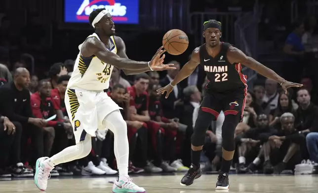 Indiana Pacers forward Pascal Siakam (43) passes as Miami Heat forward Jimmy Butler (22) defends during the first half of an NBA basketball game Thursday, Jan. 2, 2025, in Miami. (AP Photo/Lynne Sladky)