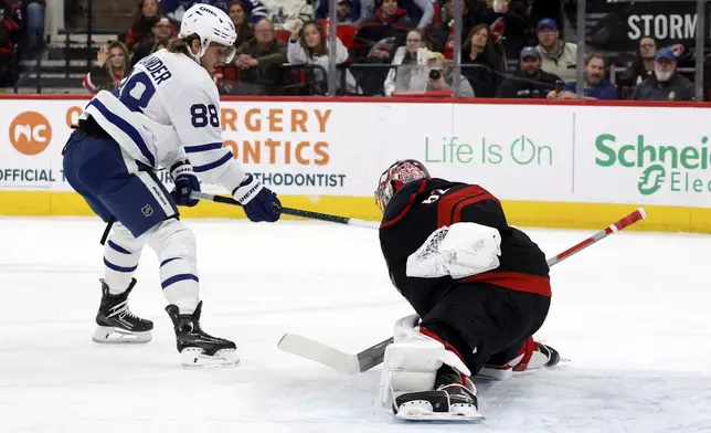 Toronto Maple Leafs' William Nylander (88) has his shot blocked by Carolina Hurricanes goaltender Pyotr Kochetkov (52) during the first period of an NHL hockey game in Raleigh, N.C., Thursday, Jan. 9, 2025. (AP Photo/Karl DeBlaker)