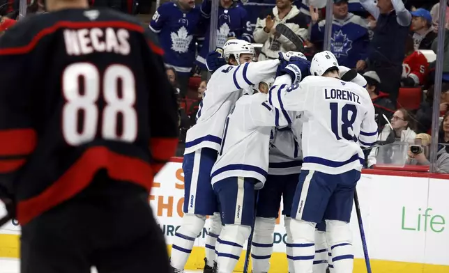 Toronto Maple Leafs celebrate a goal against the Carolina Hurricanes during the first period of an NHL hockey game in Raleigh, N.C., Thursday, Jan. 9, 2025. (AP Photo/Karl DeBlaker)