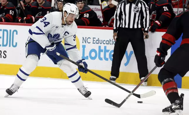 Toronto Maple Leafs' Auston Matthews (34) controls the puck against the Carolina Hurricanes during the first period of an NHL hockey game in Raleigh, N.C., Thursday, Jan. 9, 2025. (AP Photo/Karl DeBlaker)